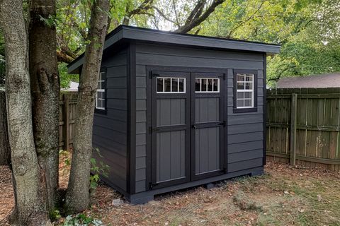 Modern black lean-to shed with Hardie panel siding
