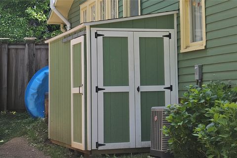 Green 6x10 lean-to shed painted to match the house